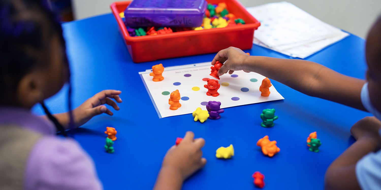 Elementary students doing an activity at their desk.