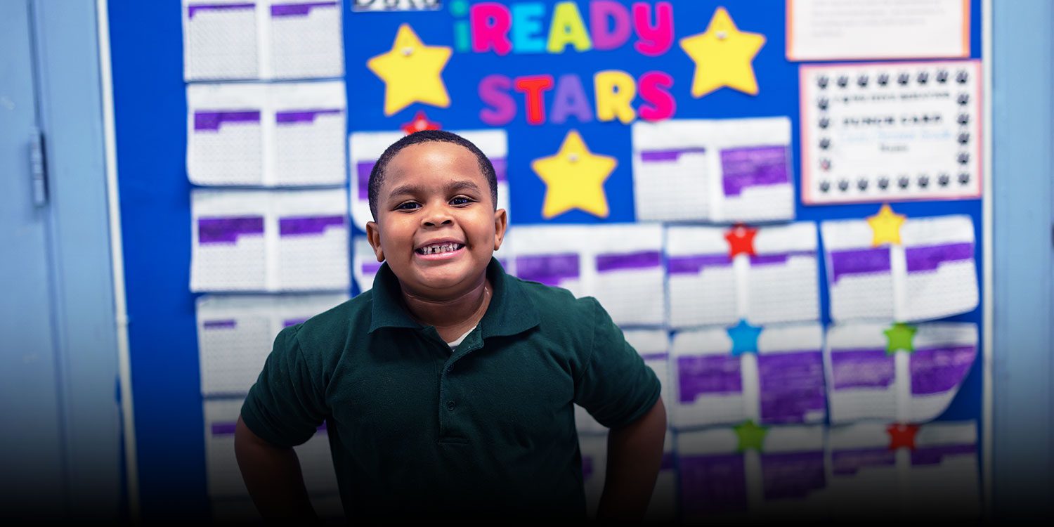 Smiling student in a classroom.