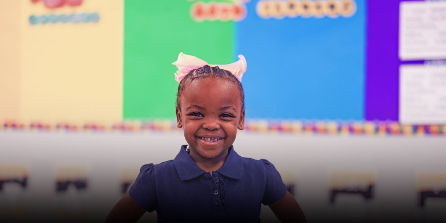 Student smiling in a classroom