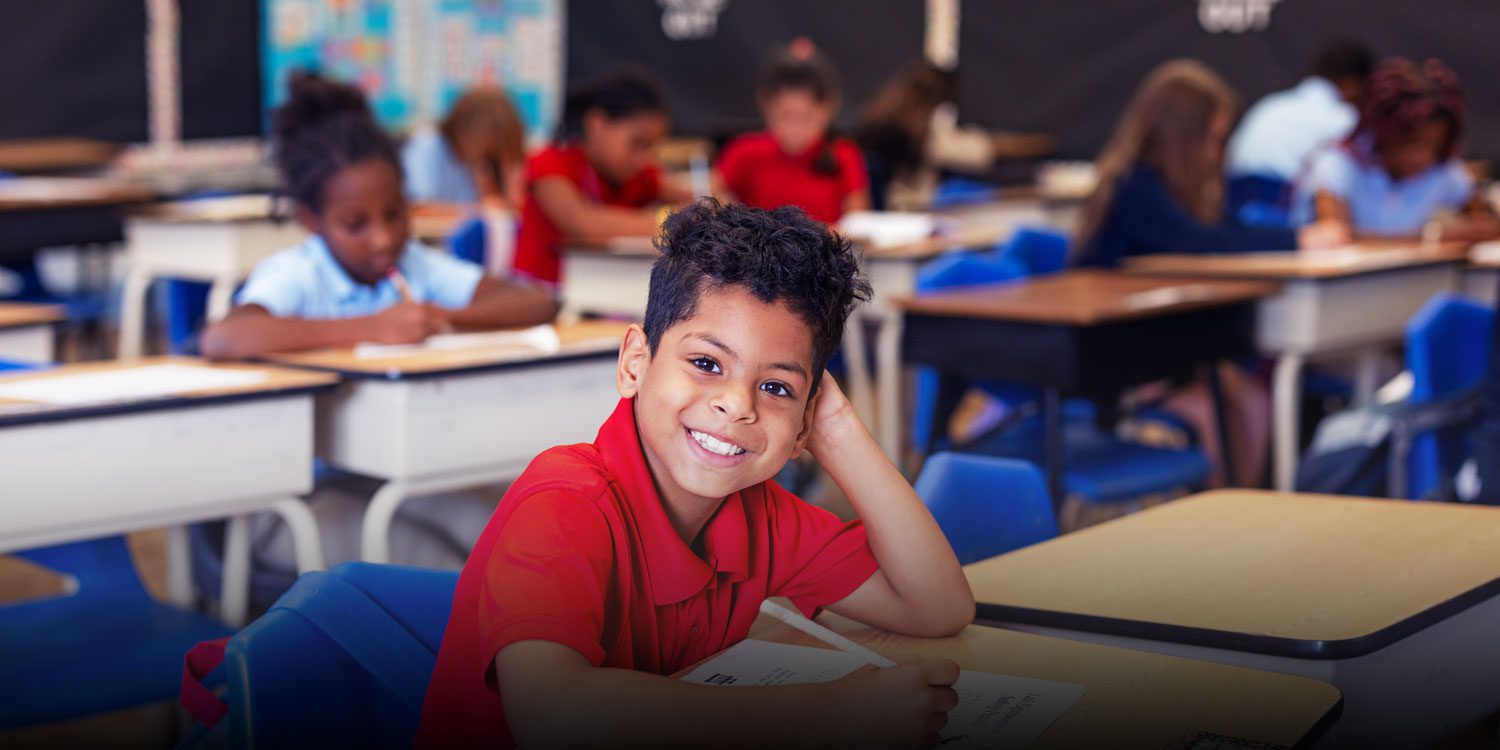 Smiling Student working on an assignment in class
