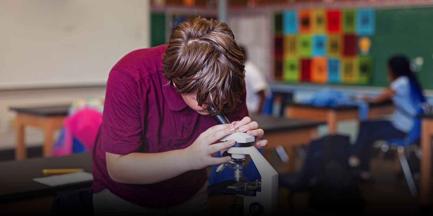 Student looking through a microscope
